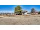 Two-story home with a stone facade, balcony, attached garage, large trees, and ranch-style fencing on an expansive lot at 12925 Sierra Cir, Parker, CO 80138