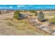 Sprawling two-story home with a stone facade, attached garage, mature trees, and ranch-style fencing around the property at 12925 Sierra Cir, Parker, CO 80138