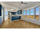 Open kitchen with blue cabinets, stainless steel fridge, island, and view outside at 12925 Sierra Cir, Parker, CO 80138
