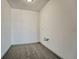 An empty laundry room with gray carpet and hookups ready for a washer and dryer at 12925 Sierra Cir, Parker, CO 80138