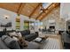 Cozy living room with wood ceiling, stone fireplace, and sliding glass doors to the outside at 12925 Sierra Cir, Parker, CO 80138