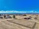 Wide view of the property showing a home, barn, large paddock, and distant city view under a bright sky at 12925 Sierra Cir, Parker, CO 80138