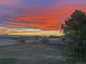 A beautiful sunset over fields with a building in the background at 12925 Sierra Cir, Parker, CO 80138