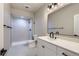 Modern bathroom features a tiled shower, white vanity, and updated fixtures at 15 S Gray St, Lakewood, CO 80226