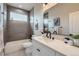 Modern bathroom with gray tiled shower/tub, white vanity, and large mirror at 15 S Gray St, Lakewood, CO 80226