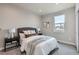 Bright bedroom with a neutral color palette, soft carpet, and a comfortable bed at 15 S Gray St, Lakewood, CO 80226