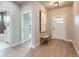 Inviting foyer with wood flooring, light fixture, bench, and a view into the main bathroom at 15 S Gray St, Lakewood, CO 80226