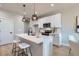 Stylish kitchen island with seating and modern pendant lighting at 15 S Gray St, Lakewood, CO 80226