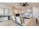 Open-concept living room with modern furniture, neutral tones, a ceiling fan, and recessed lighting at 15 S Gray St, Lakewood, CO 80226