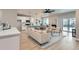 Open-concept living space featuring a living room, dining area, and white kitchen with stainless appliances at 15 S Gray St, Lakewood, CO 80226