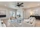 Bright living room featuring a fireplace, wood floors, neutral tones, and patio door at 15 S Gray St, Lakewood, CO 80226