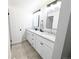 Bathroom featuring double sinks, modern fixtures, and granite countertops at 12970 E 47Th Avenue Cir, Denver, CO 80239