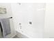 Bathroom tub/shower combo with white tile surround and neutral-colored walls at 12970 E 47Th Avenue Cir, Denver, CO 80239