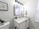 Bathroom with a granite countertop, undermount sink, sleek lighting, and a decorative mirror at 12970 E 47Th Avenue Cir, Denver, CO 80239