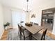 Bright dining room featuring modern lighting, access to the backyard, and seating for six at 12970 E 47Th Avenue Cir, Denver, CO 80239