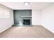 Living room with neutral carpet and sleek, painted brick fireplace with minimalist mantle at 12970 E 47Th Avenue Cir, Denver, CO 80239