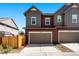 Inviting two-story townhouse with an attached garage and well-maintained landscaping at 6129 Dayton St, Denver, CO 80238