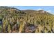 Scenic aerial view of a wooded area with mountain views, showcasing the property's prime location and natural beauty at 31219 Florence Rd, Conifer, CO 80433