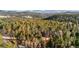 Scenic aerial view of a wooded area with mountain views, showcasing the property's prime location and natural beauty at 31219 Florence Rd, Conifer, CO 80433