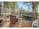 A backyard featuring seating, greenhouse, a trampoline, and mature trees, creating a private outdoor space at 31219 Florence Rd, Conifer, CO 80433