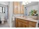 Well-lit bathroom with wooden cabinets, a sink with a countertop, and a shower-tub with patterned curtain at 31219 Florence Rd, Conifer, CO 80433