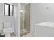 Modern bathroom featuring tiled shower with glass door, sleek toilet, and vanity sink at 31219 Florence Rd, Conifer, CO 80433