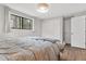 Bright bedroom featuring a comfortable bed, hardwood floors, a closet, and a large window at 31219 Florence Rd, Conifer, CO 80433
