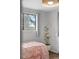 Sun-filled bedroom featuring wood floors, big windows, and plant in a decorative pot at 31219 Florence Rd, Conifer, CO 80433