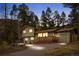 Charming two-story home featuring an inviting porch, mature landscaping, and garage, perfect for comfortable living at 31219 Florence Rd, Conifer, CO 80433