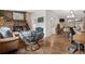 Inviting living space with hardwood floors, comfortable furniture, and a stone fireplace at 31219 Florence Rd, Conifer, CO 80433