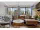 Bright living room featuring a comfortable sectional, large windows with forest views, and stylish decor at 31219 Florence Rd, Conifer, CO 80433