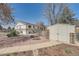 Large backyard with storage shed, garden bed, and small seating area at 4090 S Tamarac Dr, Denver, CO 80237