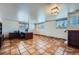 Spacious basement area with tile flooring, desk, and large windows at 4090 S Tamarac Dr, Denver, CO 80237