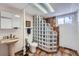 Finished basement bathroom with glass-block and a large shower at 4090 S Tamarac Dr, Denver, CO 80237