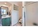 A stylish bathroom featuring a modern sink and a shower with glass-block accent at 4090 S Tamarac Dr, Denver, CO 80237