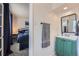 View of a bathroom sink and towel rack as seen from the adjacent bedroom at 4090 S Tamarac Dr, Denver, CO 80237