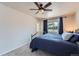 Comfortable bedroom featuring a ceiling fan and a large window with natural light at 4090 S Tamarac Dr, Denver, CO 80237