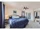 A spacious bedroom featuring carpet, modern decor, and a door to another room at 4090 S Tamarac Dr, Denver, CO 80237