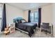 A cozy bedroom area with a desk and large window providing natural light at 4090 S Tamarac Dr, Denver, CO 80237