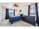 Comfortable bedroom with plush carpeting, a wrought iron bed frame, and a dark dresser at 4090 S Tamarac Dr, Denver, CO 80237