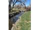 A tranquil creek with rock-lined banks and clear water offers a serene natural setting close to residential area at 4090 S Tamarac Dr, Denver, CO 80237