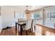 Cozy dining room featuring a wooden table, upholstered chairs, and a view of the backyard at 4090 S Tamarac Dr, Denver, CO 80237
