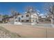 Charming raised ranch-style home featuring white exterior, brick accents, and well-maintained landscaping at 4090 S Tamarac Dr, Denver, CO 80237