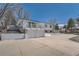 Multi-level home featuring brick and siding exterior, two car garage, and driveway at 4090 S Tamarac Dr, Denver, CO 80237