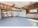 Spacious, unfinished garage with storage shelves, painted floor, and access door to the house at 4090 S Tamarac Dr, Denver, CO 80237