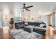 Spacious living room with a large sectional sofa, hardwood floors, and recessed lighting at 4090 S Tamarac Dr, Denver, CO 80237