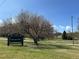 Sign for Rosamond Park next to bare tree with path and grass at 4090 S Tamarac Dr, Denver, CO 80237
