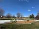 A playground with a basketball court and various climbing structures on a mulch surface is ready for active  at 4090 S Tamarac Dr, Denver, CO 80237