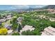 Expansive view of a neighborhood with lush greenery and stunning mountain views, with nearby community amenities at 6503 Big Horn Trl, Littleton, CO 80125