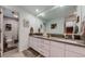 Bright bathroom featuring a double vanity, an integrated door to the shower and contemporary fixtures at 6503 Big Horn Trl, Littleton, CO 80125